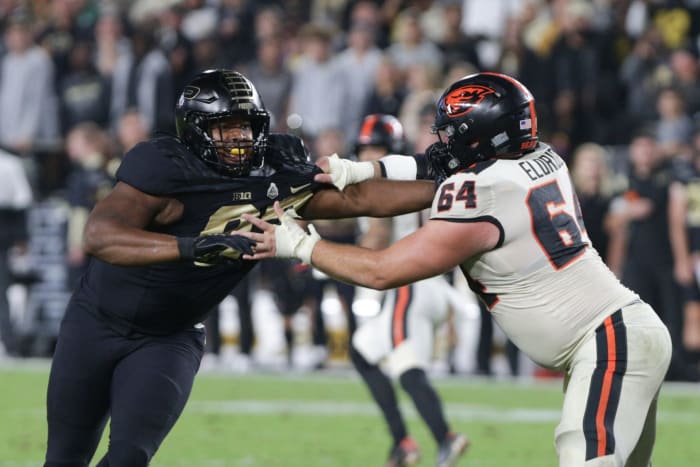 Purdue defensive tackle Prince James Boyd Jr. (93) is blocked by Oregon State offensive lineman Nathan Eldridge (64).